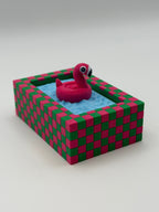 A pink flamingo in a blue pool fidget clickers with a green keychain and textured pink and green external base.