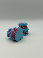 Two pink and blue layered cake fidget clickers.