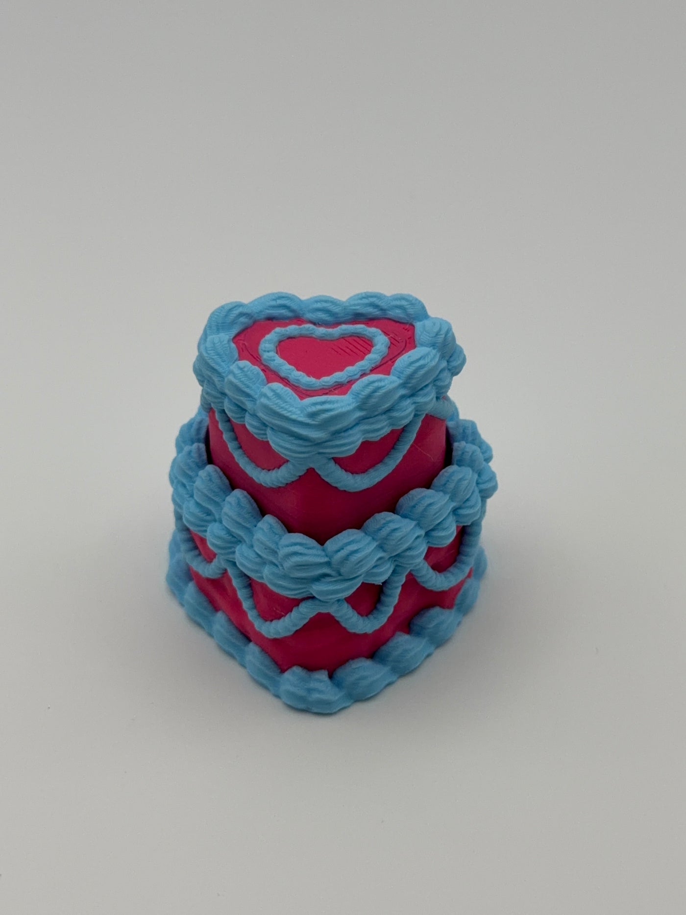 A pink and blue layered cake fidget clicker.