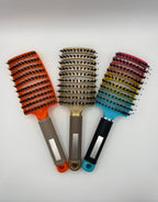 Three sensory hair brushes. Rainbow, gold and orange.