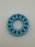 Blue plastic ring with star-shaped cutouts on a gray background