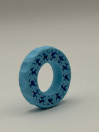 Blue plastic ring with a textured pattern on a gray background
