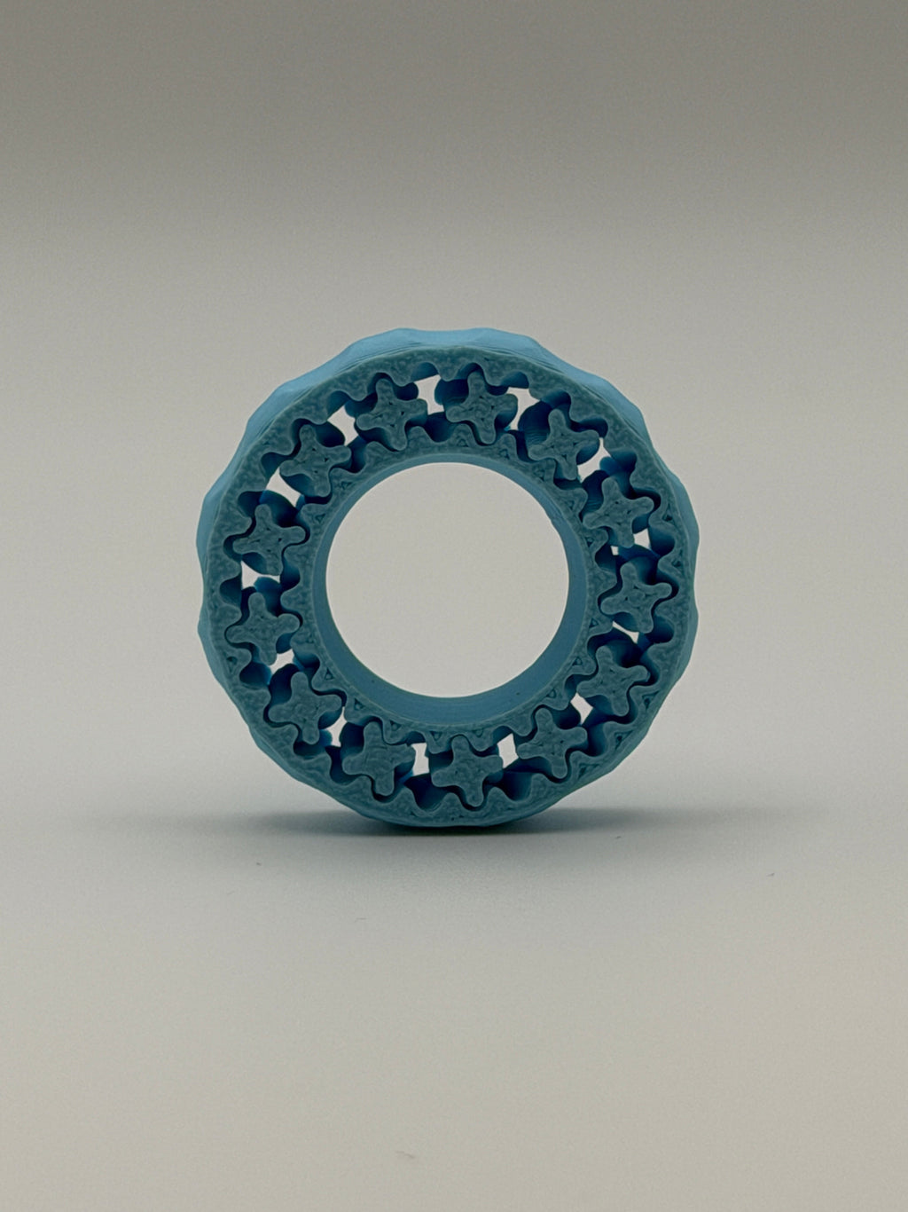 Blue circular ring with a textured surface on a gray background