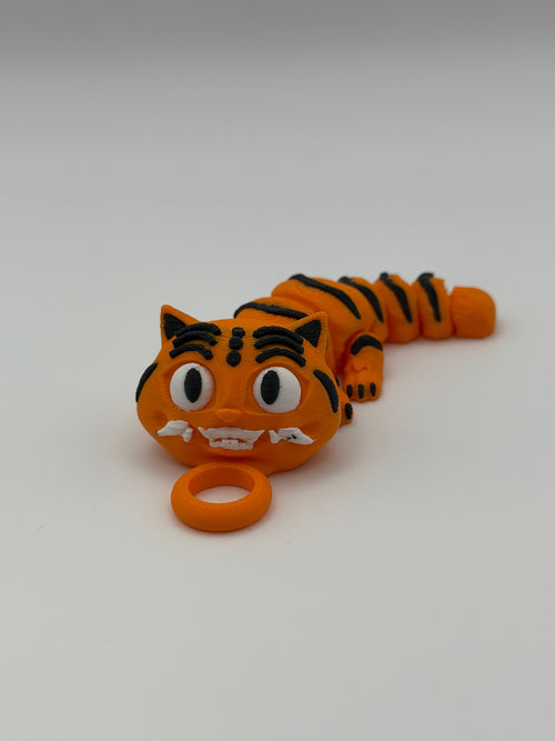 An orange and black striped small tiger articulated toy with grinning teeth and a keychain attachment.