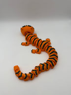 Large orange articulated tiger with black stripes. 