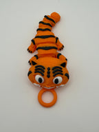 Small orange tiger with black stripes and grinning teeth with a keychain attachment. 