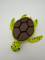 A green and brown shelled fidget clicker turtle.