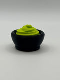 Green wasabi fidget clicker in a black bowl.