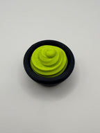 Green wasabi fidget clicker in a black bowl.