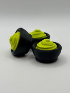 3 Green wasabi fidget clickers in a black bowl.
