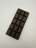 Dark chocolate bar squish toy on a light gray background