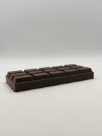 Dark chocolate bar squish toy on a white background