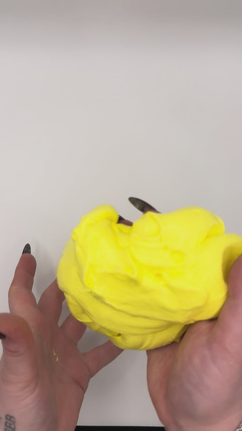 Video of banana lollies butter slime in hands.