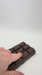 Dark chocolate bar squish toy on a white background