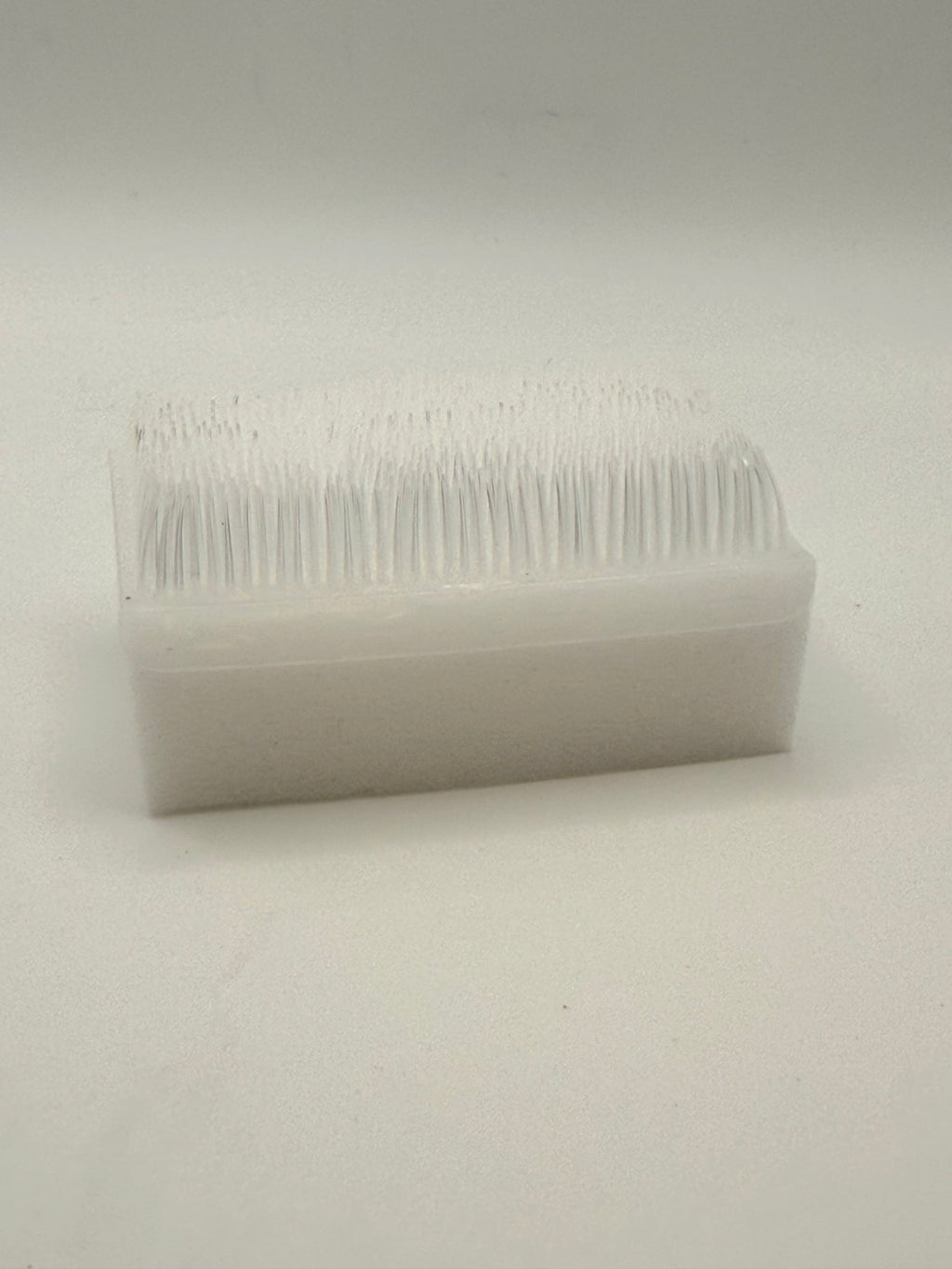 Rectangular white silicone wash brush.