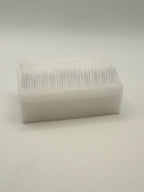 Rectangular white silicone wash brush.