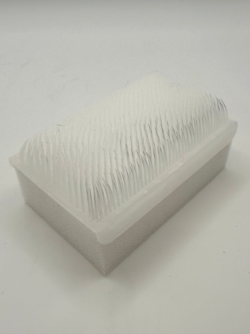 Rectangular white silicone wash brush.