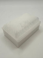 Rectangular white silicone wash brush.