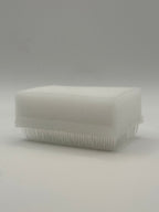 Rectangular white silicone wash brush with sponge.