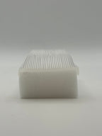 Rectangular white silicone wash brush with sponge.