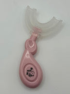 Pink U-shaped sensory toothbrush on a white background.