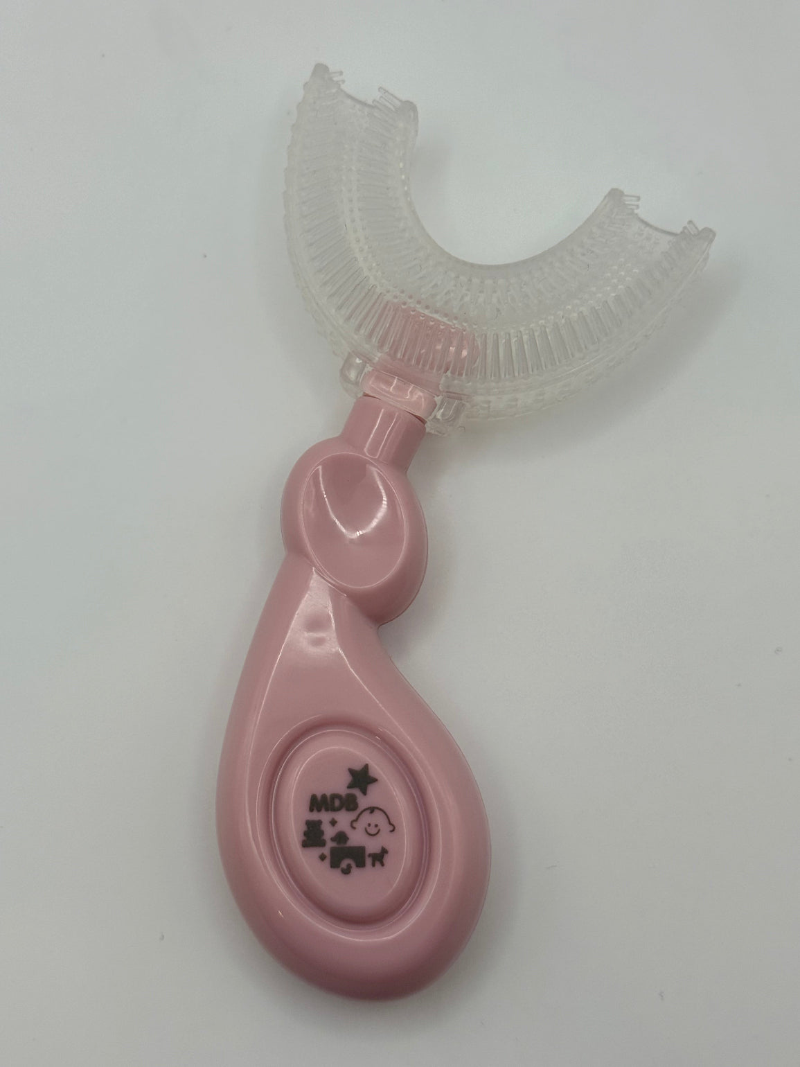 Pink U-shaped sensory toothbrush on a white background.