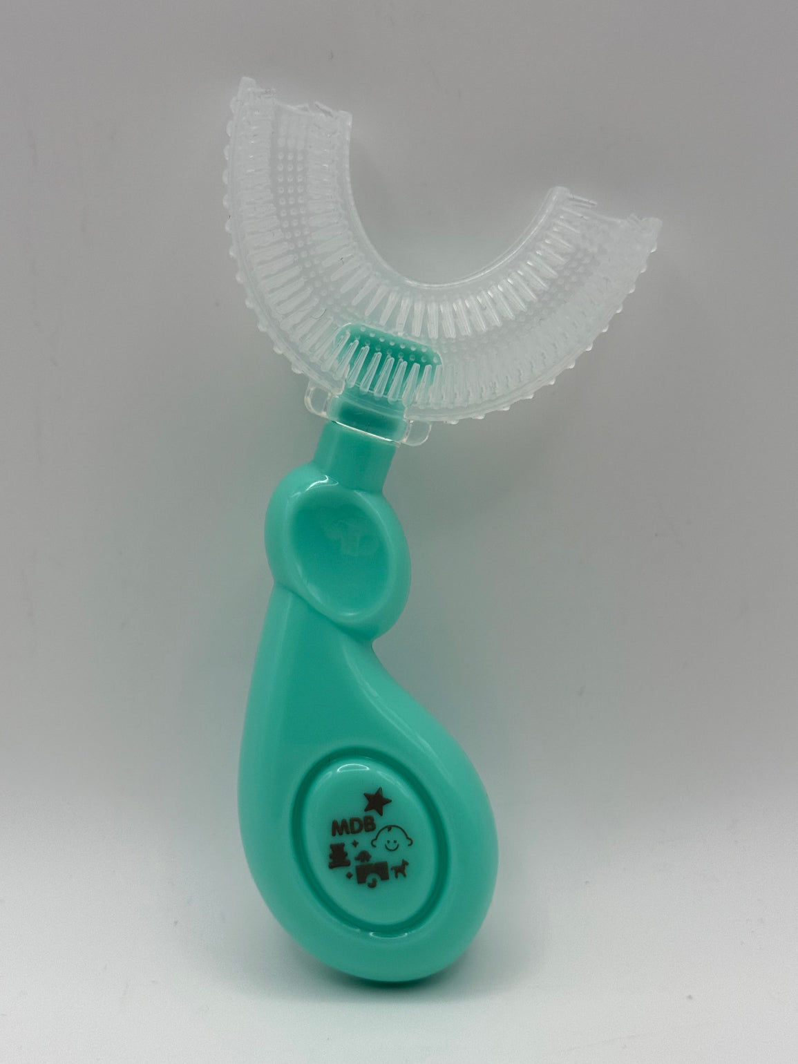 Green U-shaped sensory toothbrush on a white background.