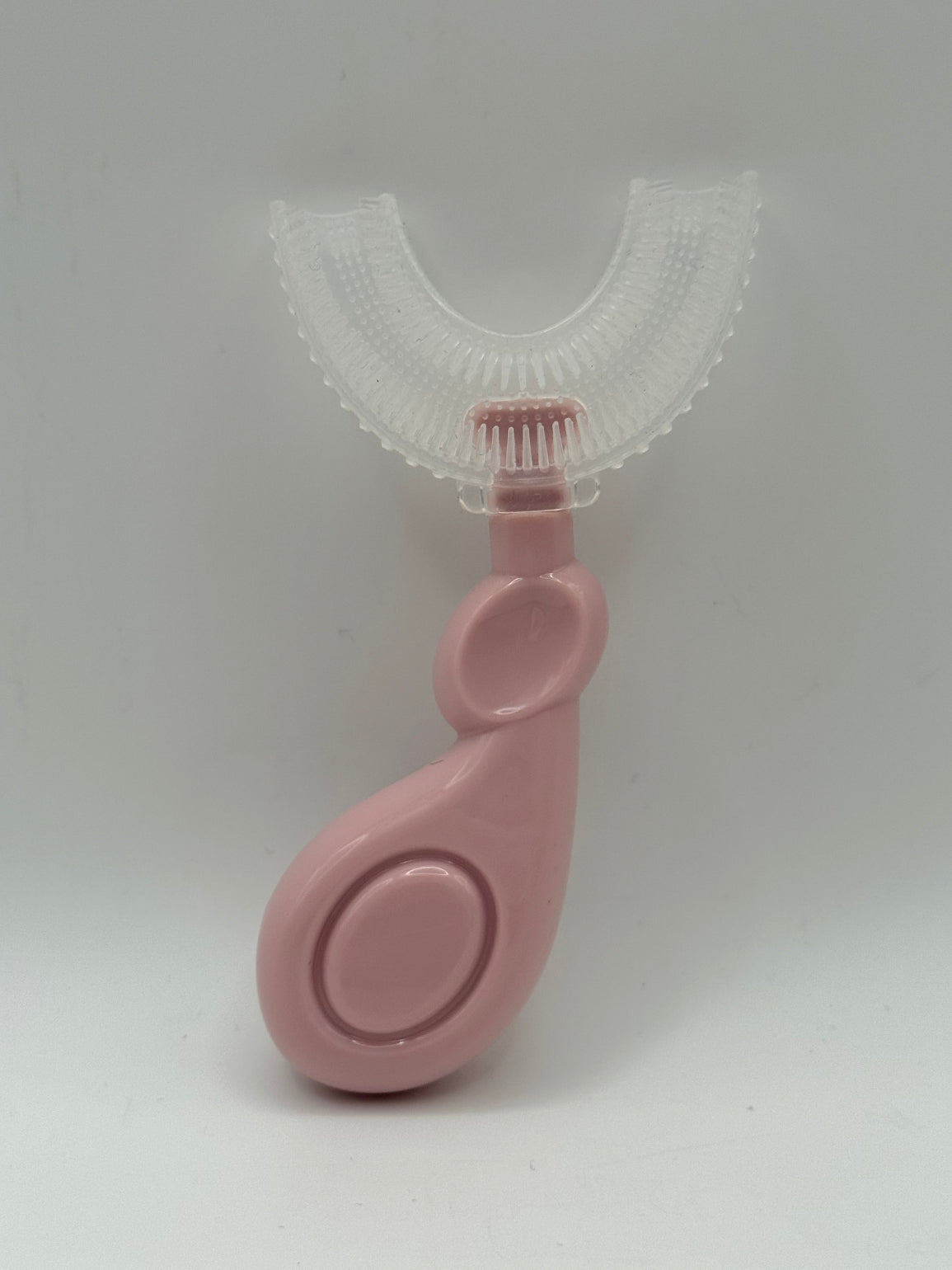 Pink U-shaped sensory toothbrush on a white background.