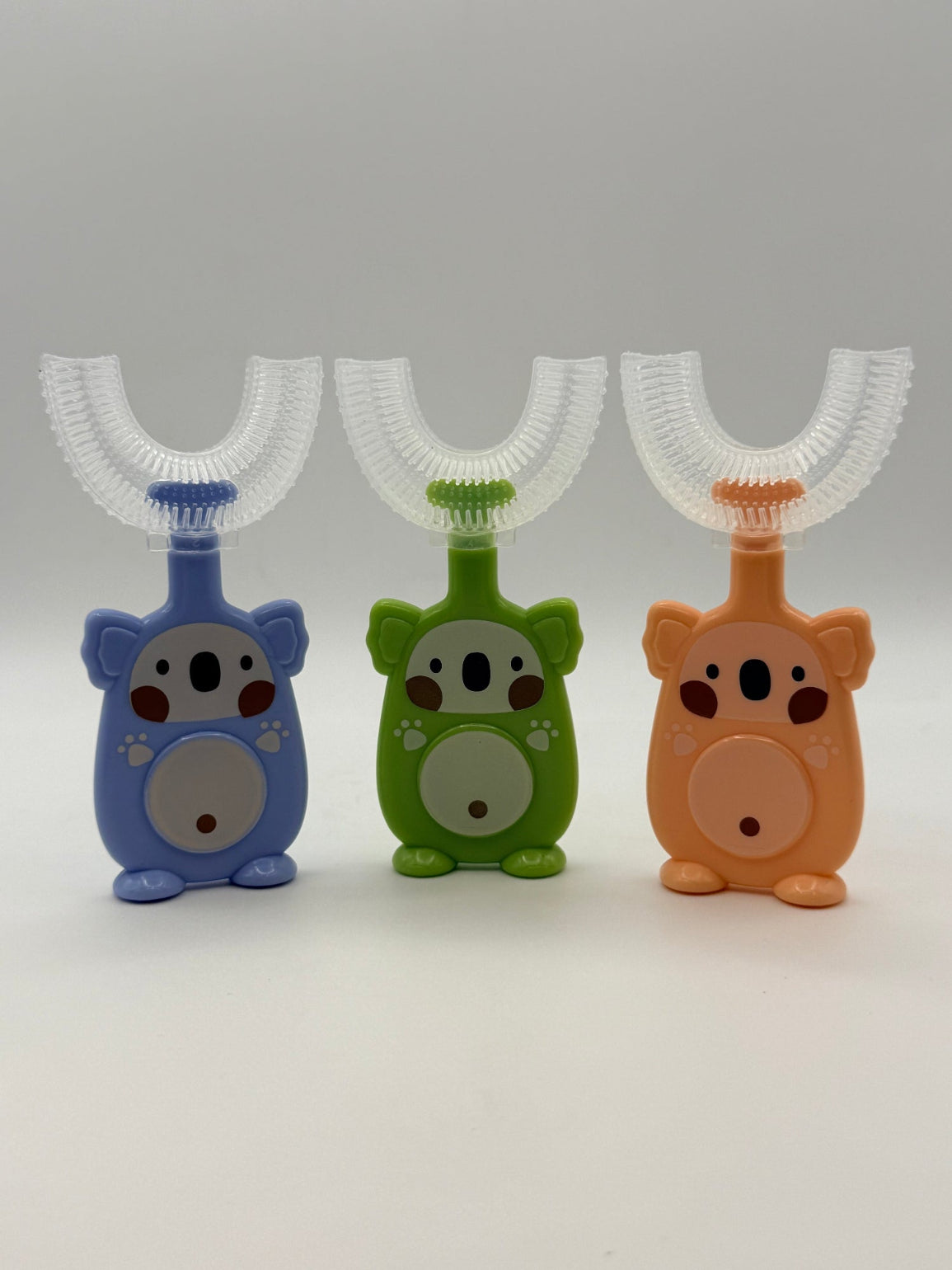Green, blue, and orange koala U-shape sensory tooth brushes.